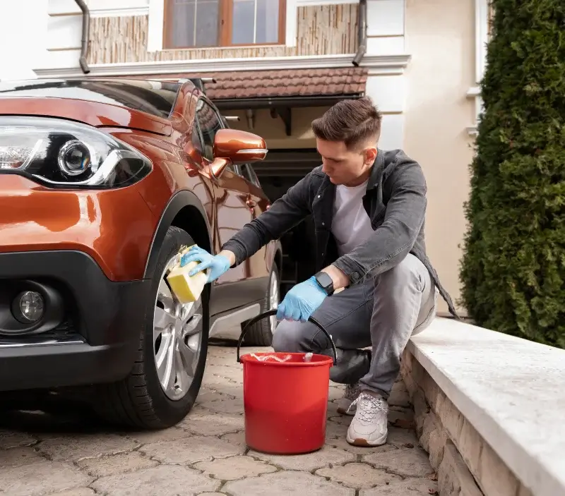 Lavage auto à domicile Rouxmesnil-Bouteilles : professionnel intervenant sur un véhicule